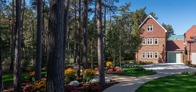 An image of a Berkeley development next to beautiful woodland