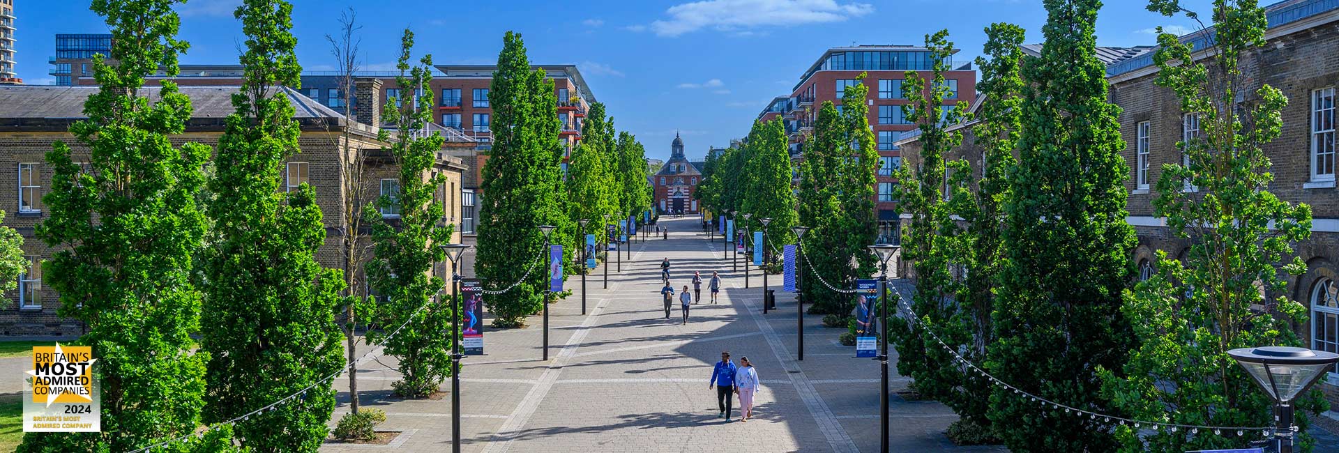 An exterior image of Royal Arsenal Riverside with Britain's Most Admired Logo displayed