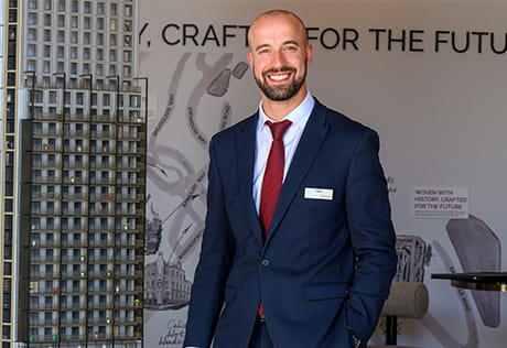 An image of an employee stood in the sales and marketing suite