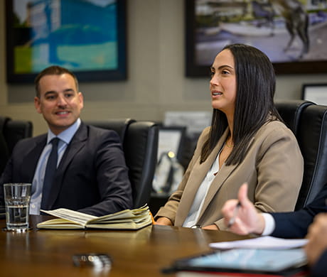 An image of people in a meeting room talking