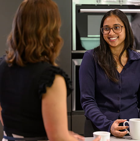 An image of 2 colleagues talking together 