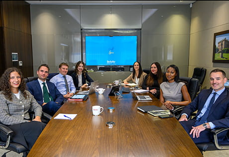 An image of people all sat around a board room table