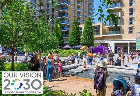 An image of the town square at Kidbrooke Village with the Our Vision 2030 logo
