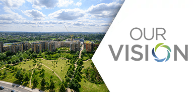 An exterior aerial image of Kidbrooke Village next to the Our Vision logo