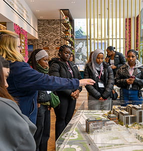 Members of the public looking at model of a development