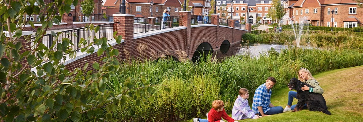 Exterior image of a family enjoying the greenery at Hartland Village