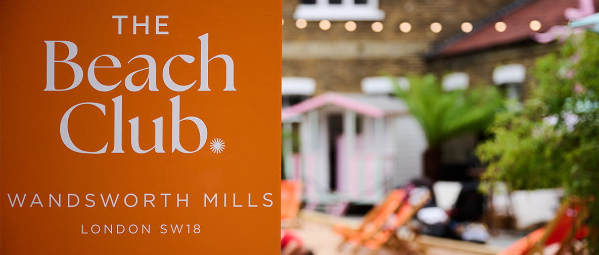 An image of The Beach Club logo with an image of The Beach Club next to it