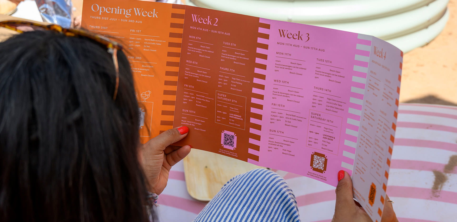 An image of a women looking at the Beach Club itinerary 