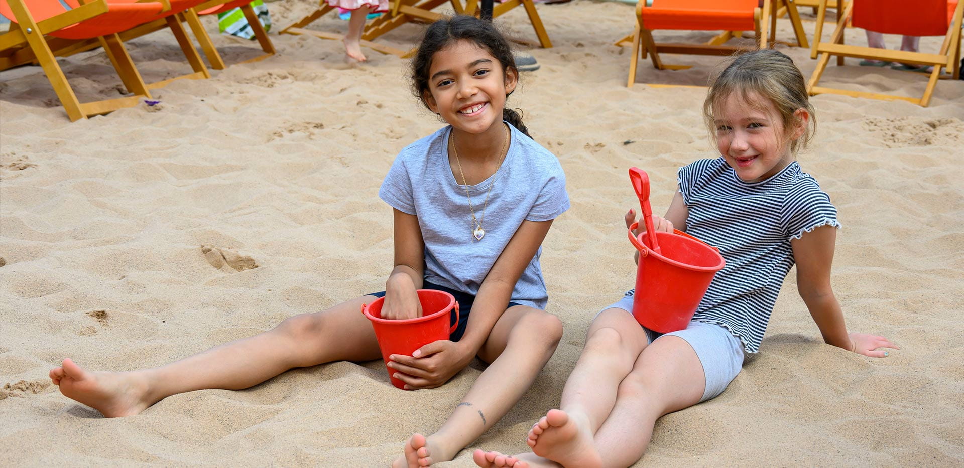 An image of children playing in the Sand at The Beach Club