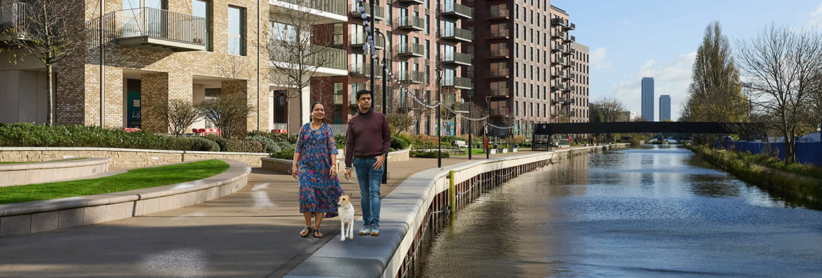 Residents walking along the canal at a Berkeley development
