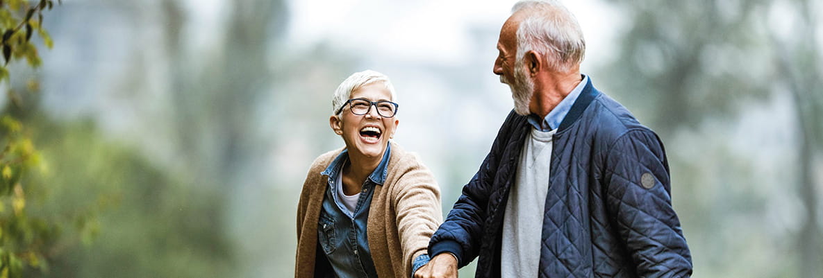 Playful senior couple having fun in the park.