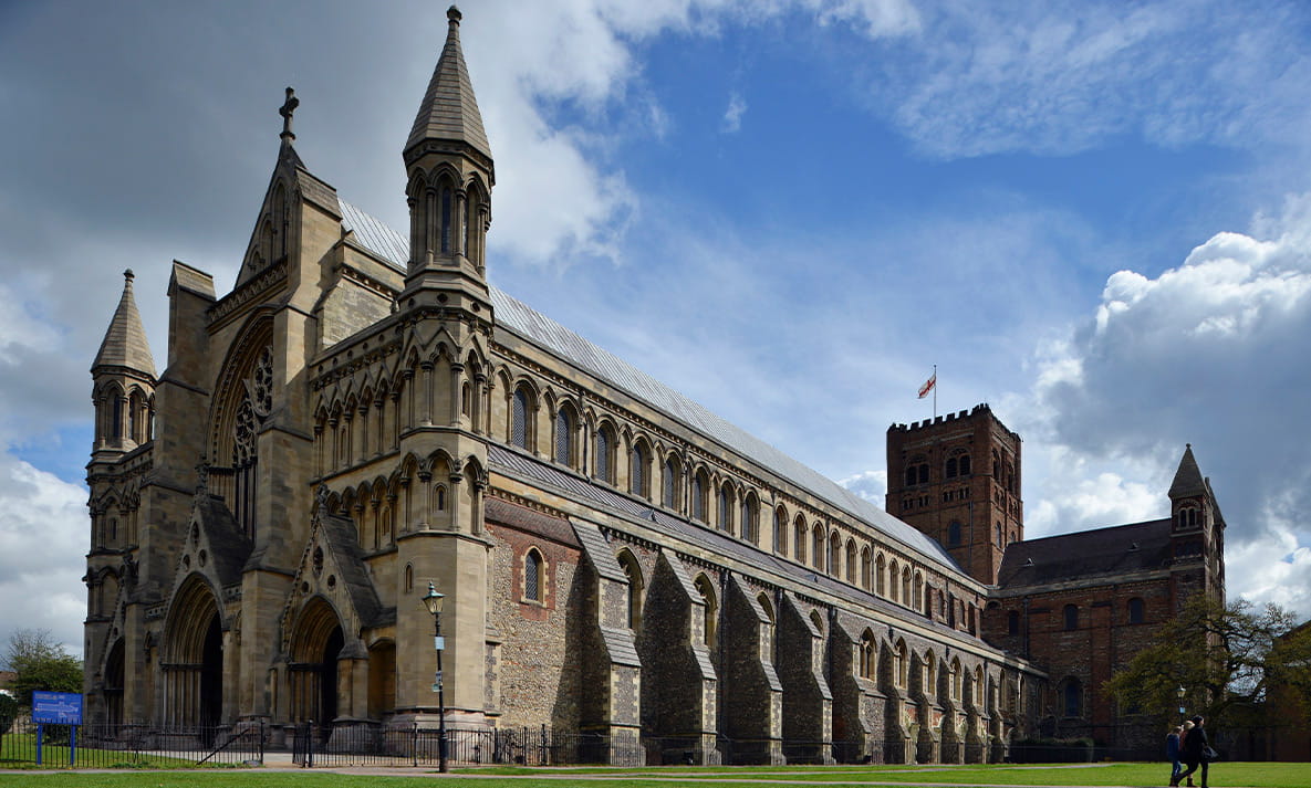An outside view of St Albans Cathedral on a sunny day.