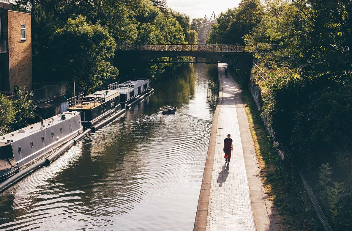 A person taking a stroll along a countryside canal