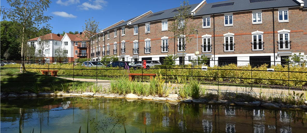 New build homes overlooking a pond and walking route at Ryewood development, near Sevenoaks.