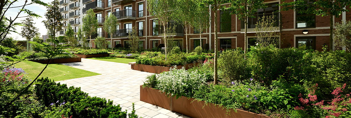 CGI of exterior new build block of flats with landscaped garden adjacent.