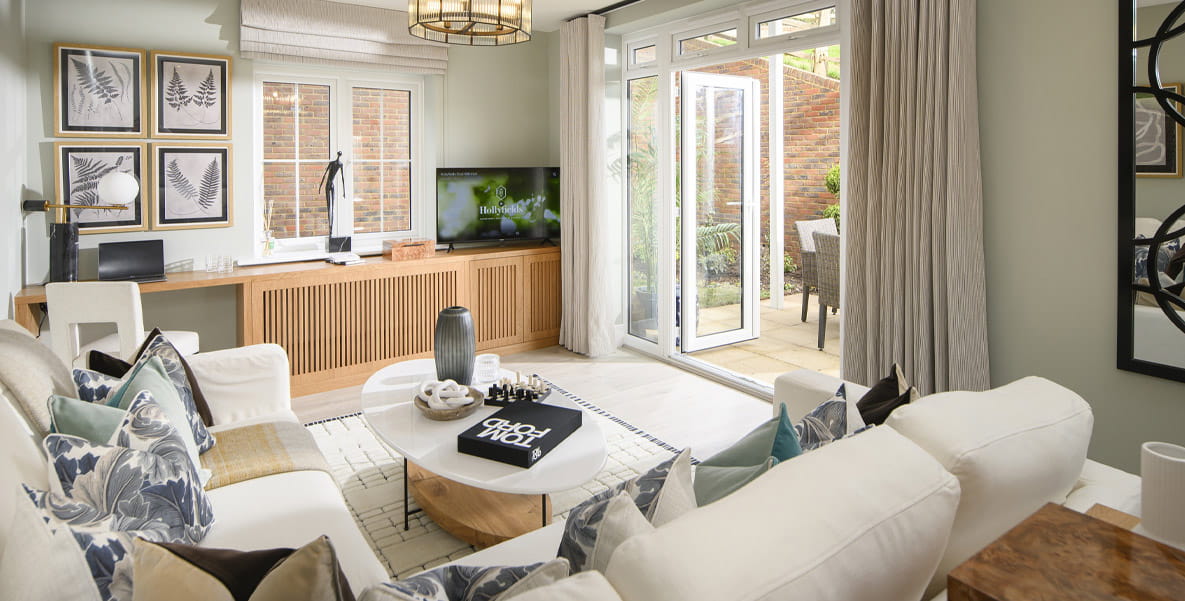 An example new build home at Hollyfields development. The modern lounge includes French doors that lead out to the garden.