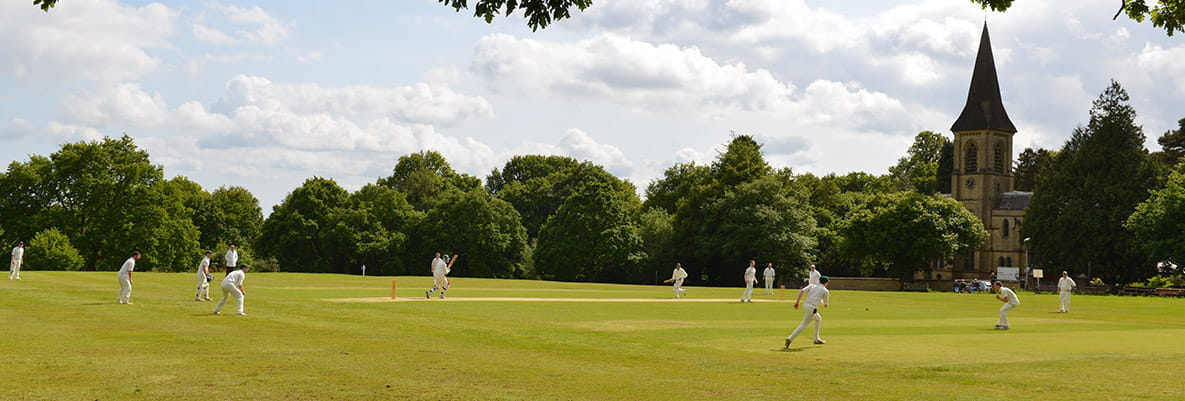 A field with people playing cricket in Tunbridge Wells.