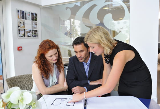 A couple examining a new build home floorplan