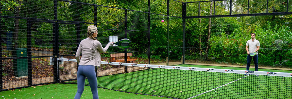 An image of two people playing padel