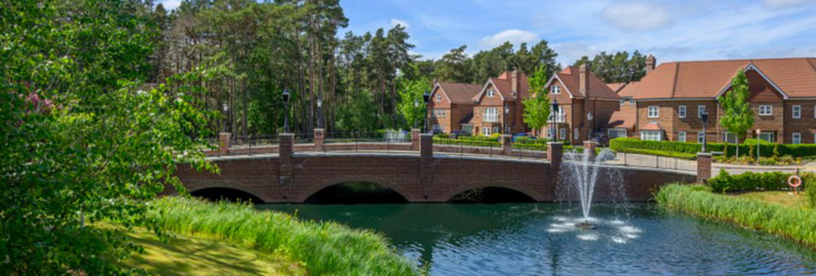 Bridge and green space leading into Hartland Village