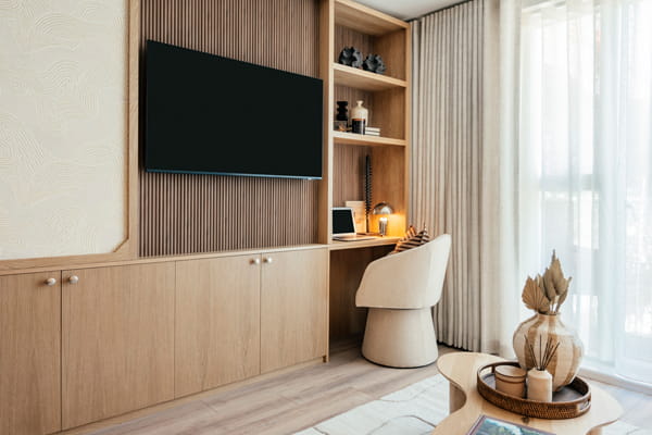 Modern designed living space in light brown, cream and beige palette, wall mounted TV