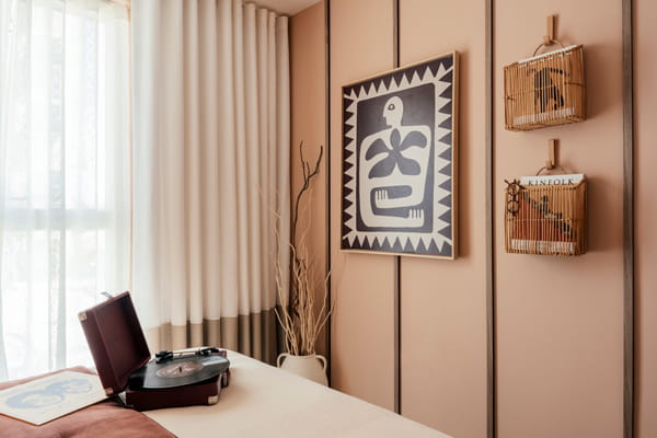 Wall hangings at end of bed, cream/beige and light brown design colour palette