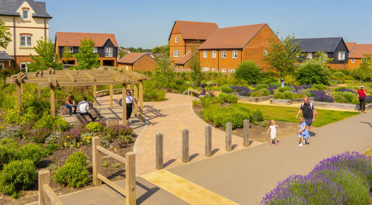 An image of local residents using the community herb garden at Woodhurst Park