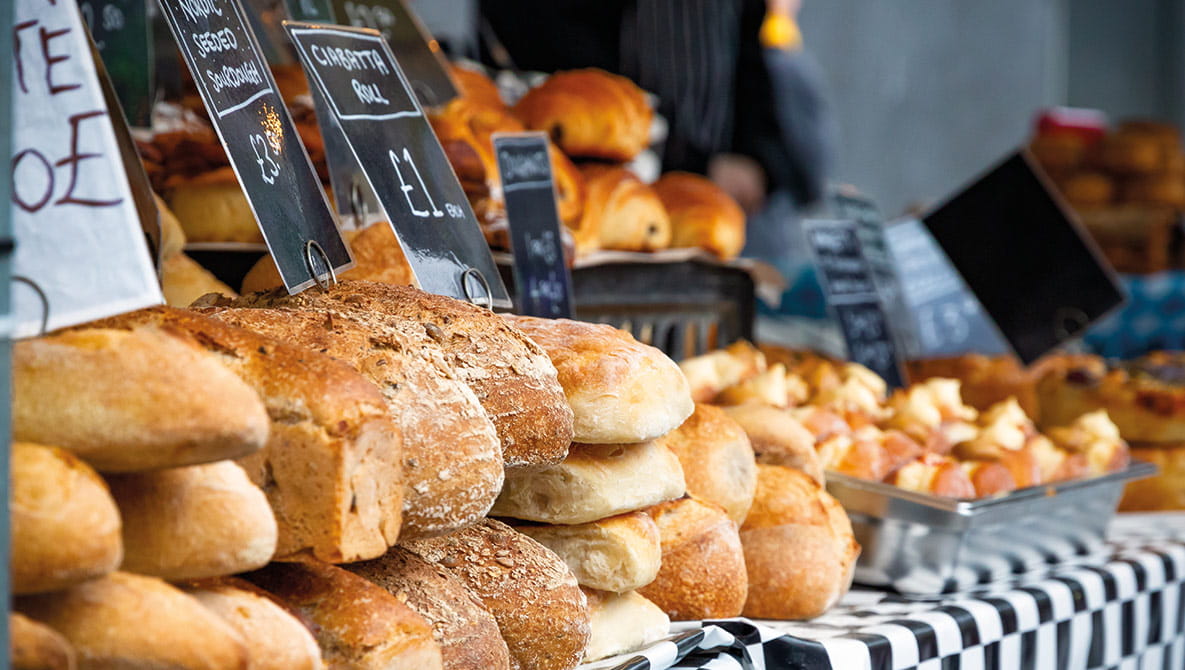 A local bakery stall with a selection of different breads for sale.