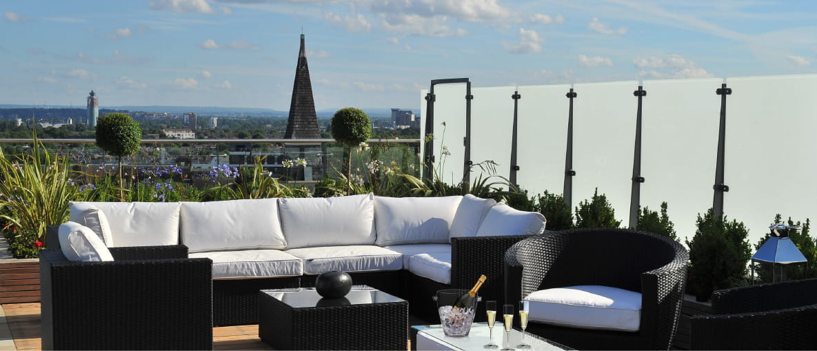 A penthouse terrace with planting around the seating