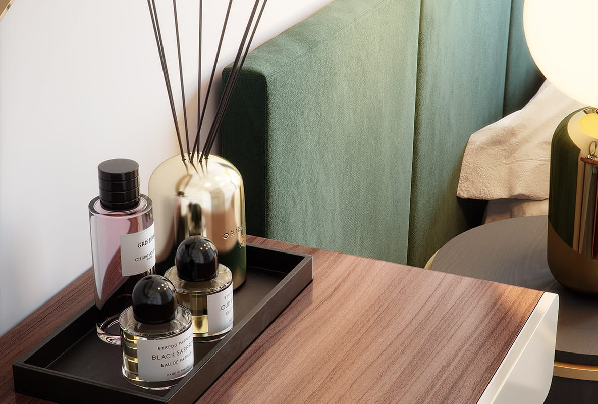 A close-up of a reed diffuser and several perfume bottles.