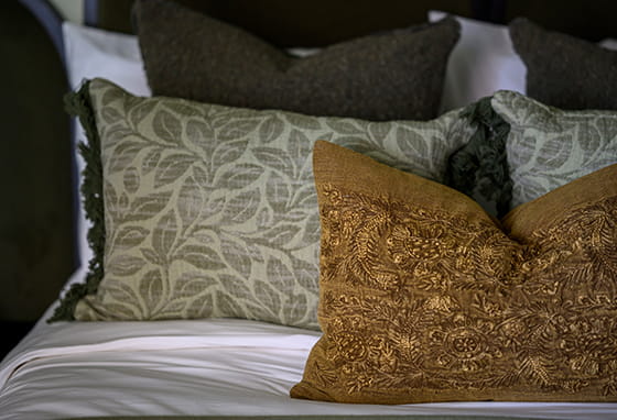A close up image of pillows on a Bed