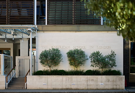 The text 'The American School in London' carved in to facade of building
