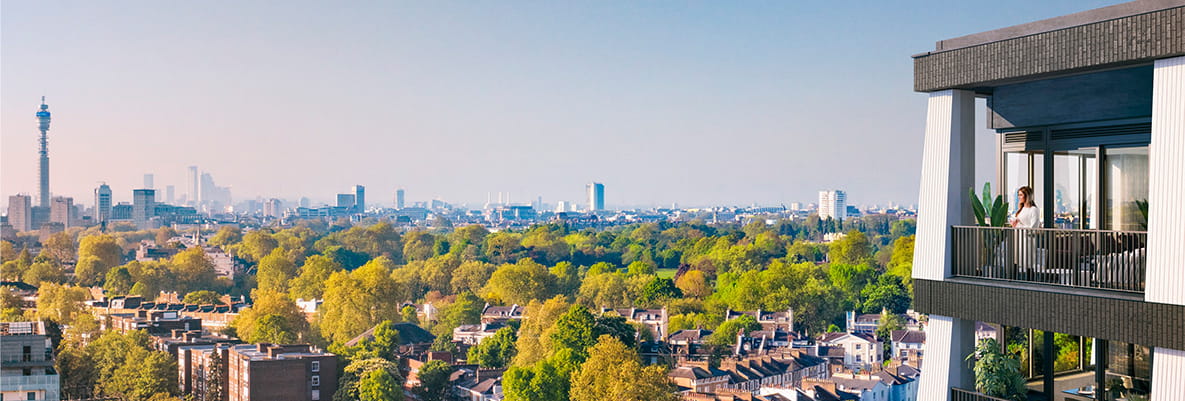 View of green landscape with building and towers along the skyline