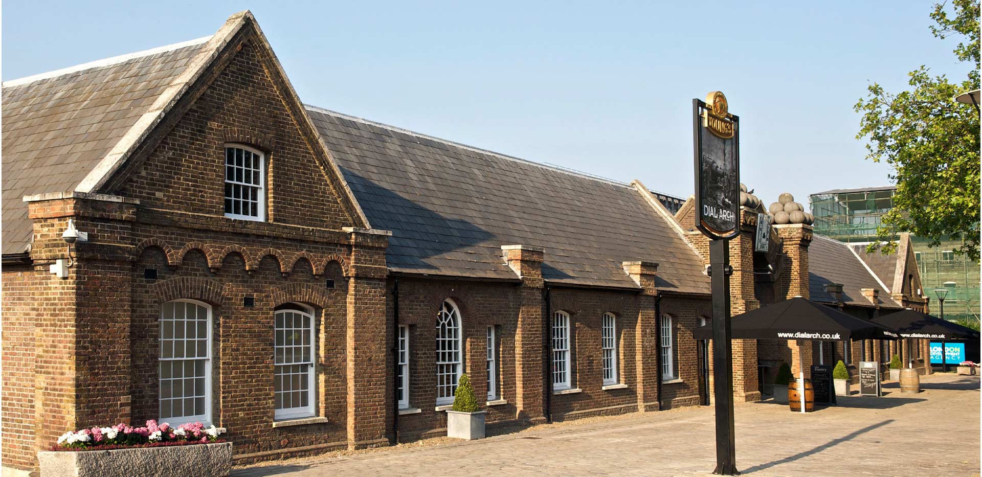 Dial Arch Square at Royal Arsenal Riverside—a 1700s building restored to Young’s public house at a development by Berkeley Group.