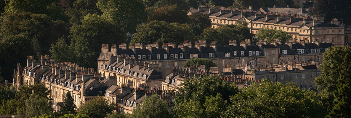 Terraced residential housing amongst greenery.