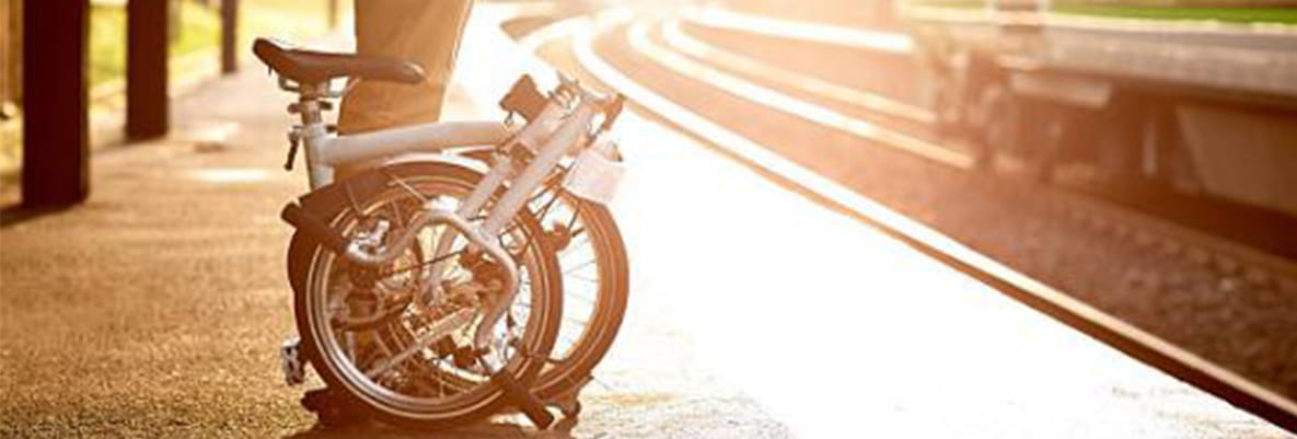 An image of a person with a bike at a train station