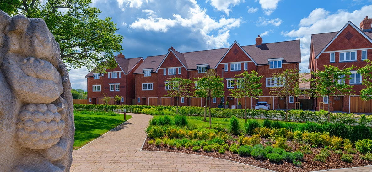 A selection of homes located at Highwood Village. The properties overlook large walkways and greenery.