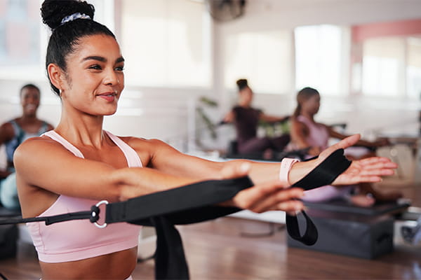 a pilates class in progress, using machines for exercise.