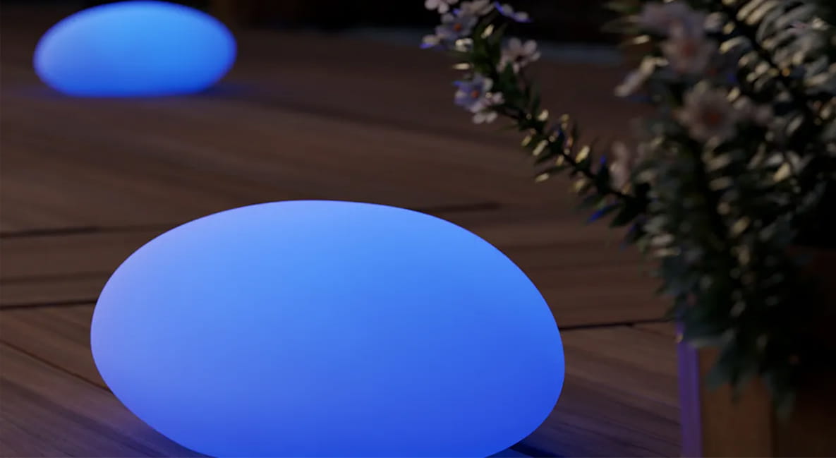 Blue glowing LED pebble lights on a deck.