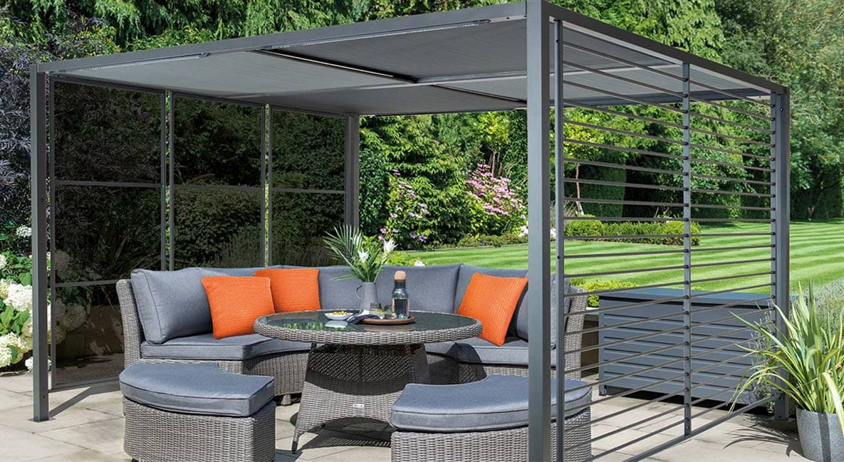 An outdoor seating area under a modern metal pergola.