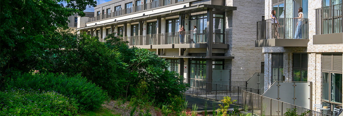 CGI of new build flats with lush, green, landscaped background