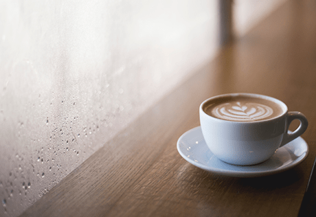 A mug and coaster placed on a table in a café in Battersea. 