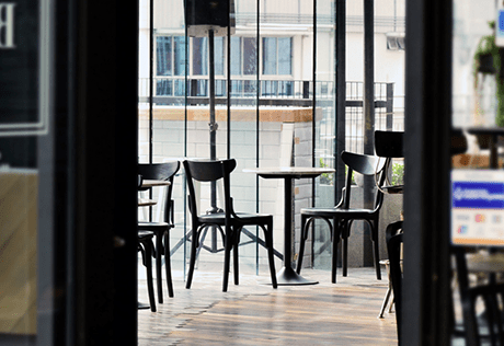 The inside of a coffee shop in Battersea, featuring chairs and tables for socialising. 