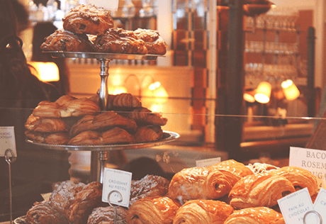 A selection of freshly baked breads, pastries and savoury treats, laid out by the counter in a coffee shop in Battersea. 