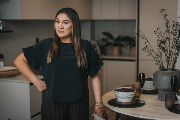 Faiza posing in modern designed, kitchen dining space.