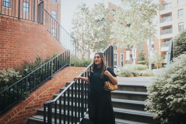 Faiza posing on outdoor staircase.