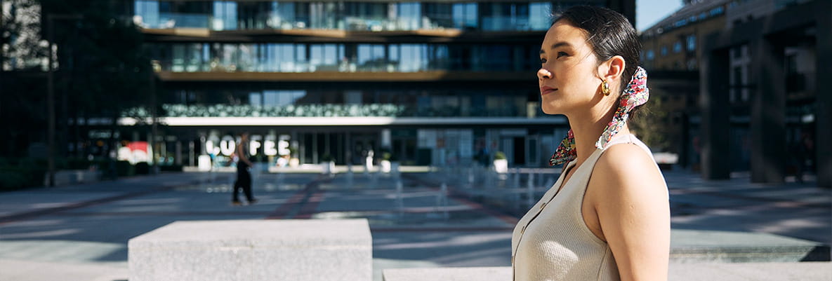 An image of a woman sat outside of London Dock
