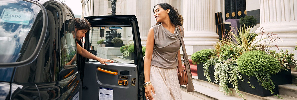 An image of a couple getting out of a Taxi