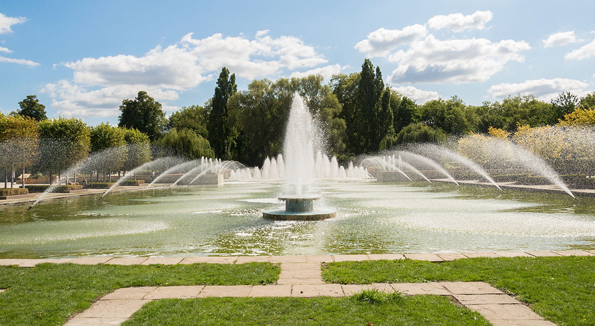 A large water fountain, surrounded by smaller water fountains, takes pride of place at Battersea Park.