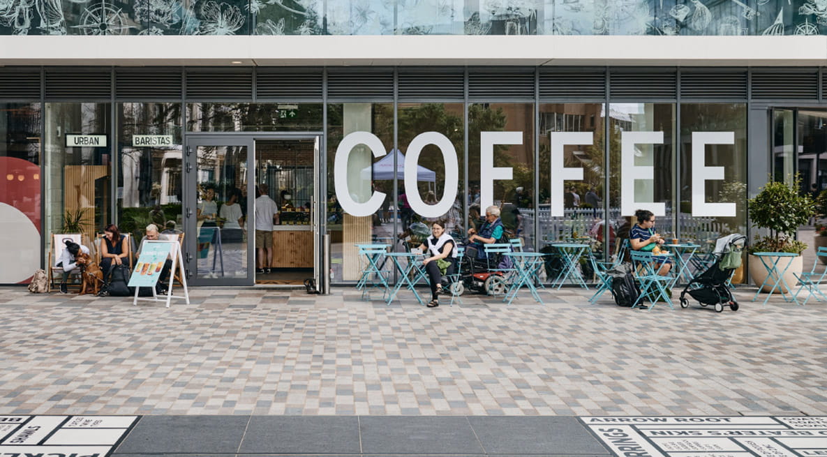 Local residents enjoy a nearby coffee shop at London Dock